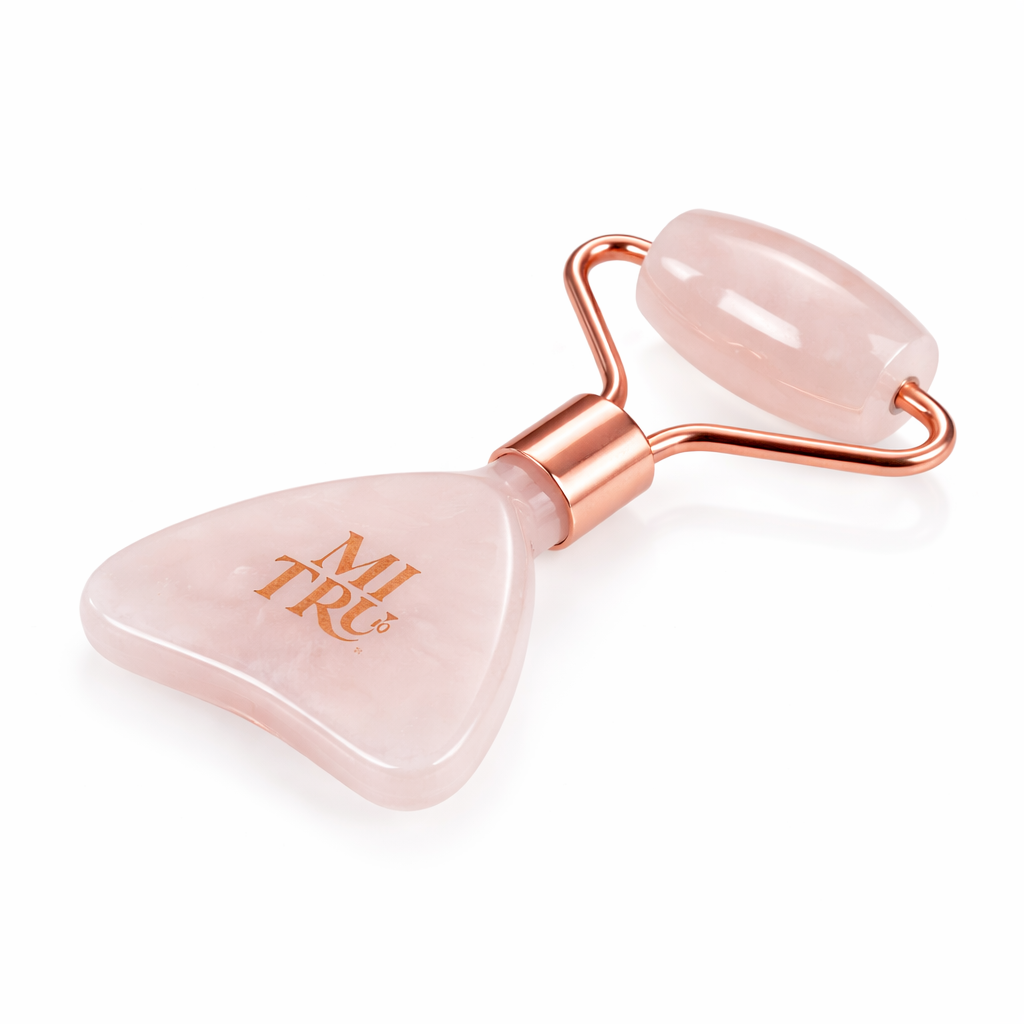 Rose quartz facial roller with rose gold accents on a white background, branded &