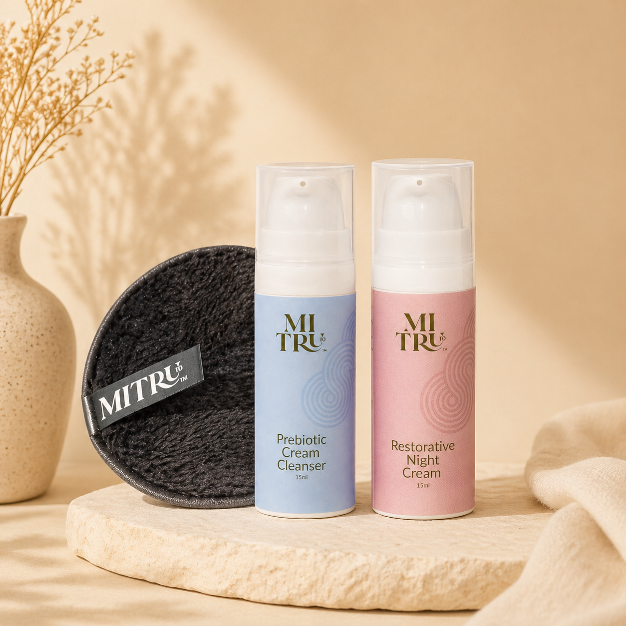 Two skincare products and a black pad on a beige surface with a neutral background